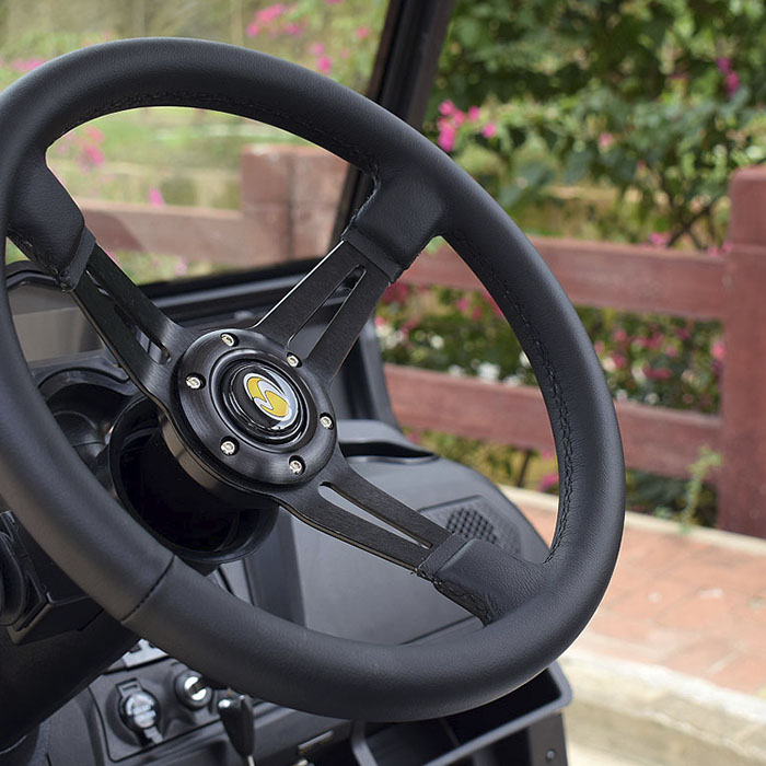 The steering wheel of a bintelli beyond street legal golf cart