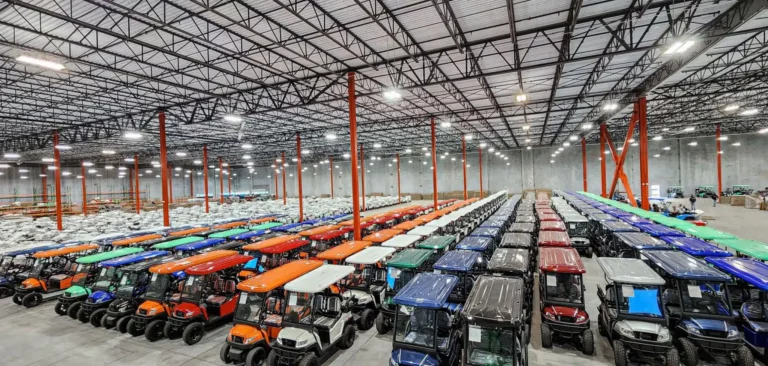 Overhead shot ofBintelli Golf Cart Warehouse with Bintelli Beyond Lifted 4PR street legal golf cart and Bintelli Beyond 4PR street legal golf cart fleet in Ocean Blue, Black, Burgundy, Hydro, Mint, Navy, Red, Titanium and White