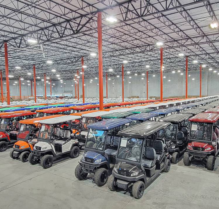 Overhead shot ofBintelli Golf Cart Warehouse with Bintelli Beyond Lifted 4PR street legal golf cart and Bintelli Beyond 4PR street legal golf cart fleet in Ocean Blue, Black, Burgundy, Hydro, Mint, Navy, Red, Titanium and White