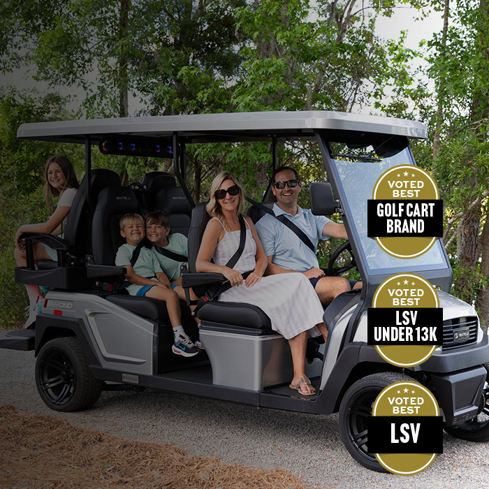 family on a bintelli 6 seater golf cart in silver at the lake