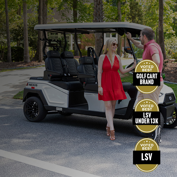 couple standing next to the bintelli nexus 4 seater golf cart