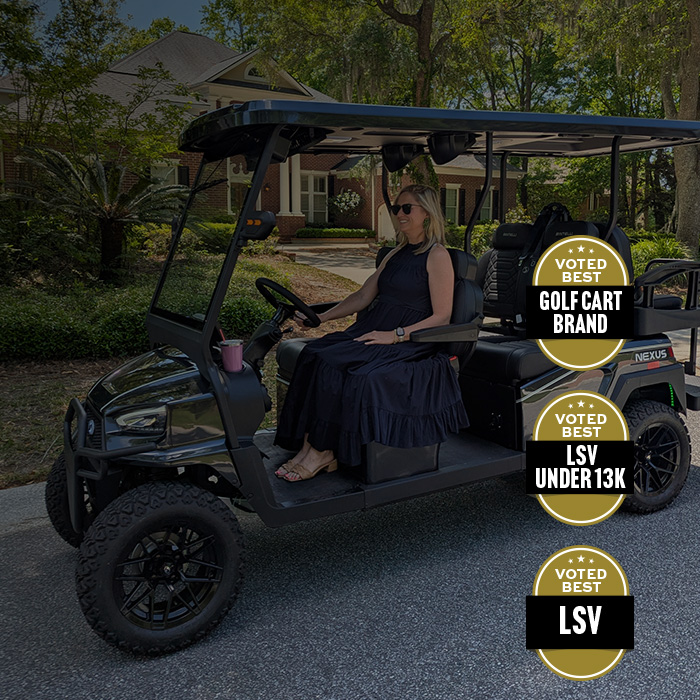 woman driving black nexus 6 seater lifted golf cart with Bintelli award badges